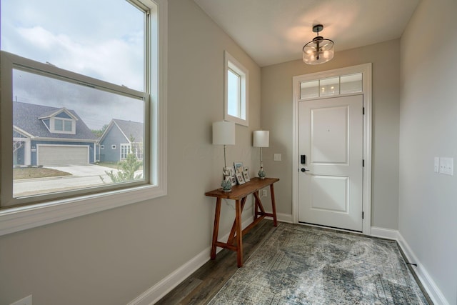 entrance foyer featuring dark hardwood / wood-style flooring and an inviting chandelier