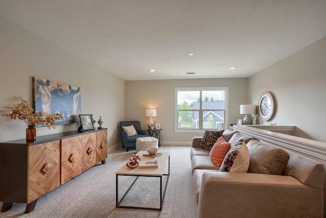 living room with light colored carpet and a textured ceiling