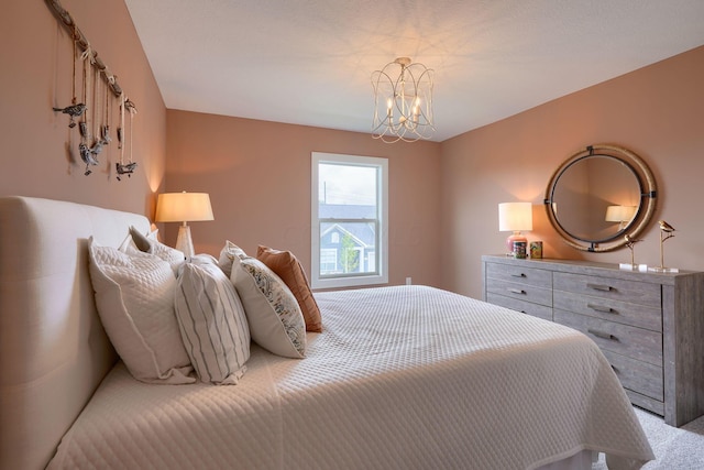 carpeted bedroom featuring a chandelier