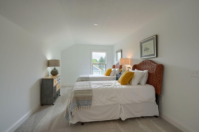 bedroom featuring carpet flooring and lofted ceiling