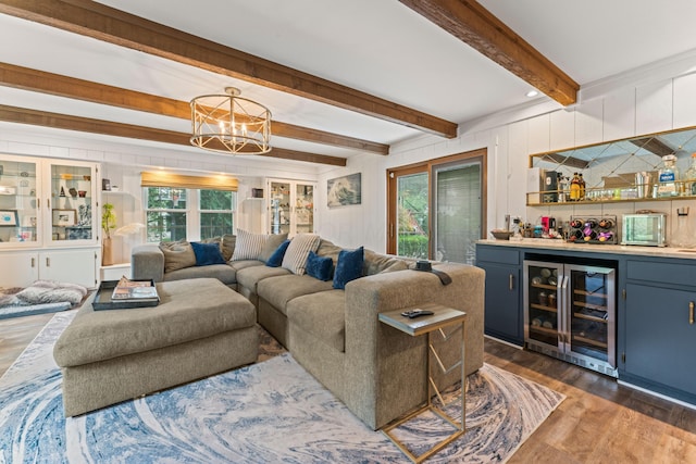 living room featuring a wealth of natural light, dark hardwood / wood-style flooring, wine cooler, and indoor bar