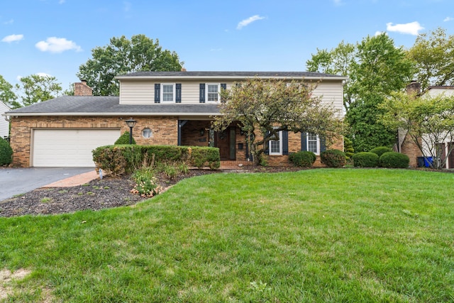 front of property with a front yard and a garage