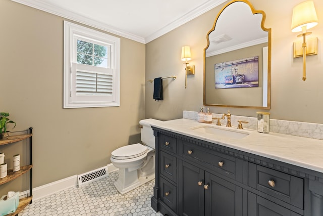 bathroom with tile patterned floors, vanity, toilet, and ornamental molding