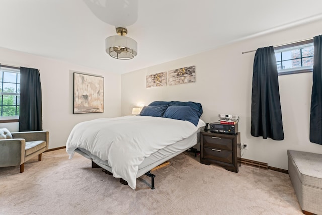 bedroom featuring light carpet