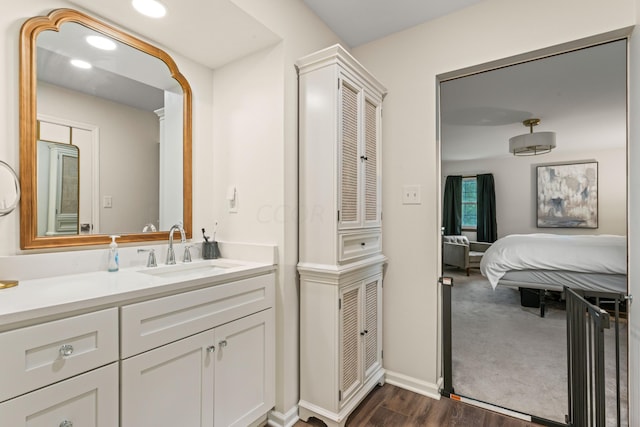 bathroom with hardwood / wood-style floors and vanity