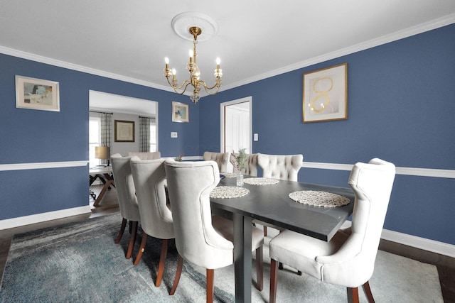 dining space featuring an inviting chandelier, dark wood-type flooring, and ornamental molding