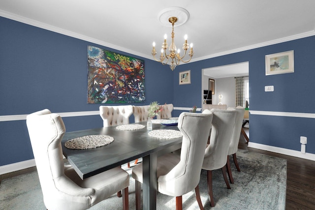 dining space featuring dark hardwood / wood-style floors, an inviting chandelier, and crown molding