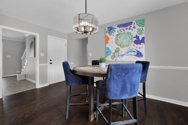 dining area featuring dark hardwood / wood-style flooring and a chandelier