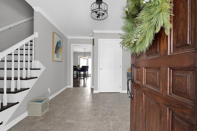 entrance foyer featuring an inviting chandelier and ornamental molding