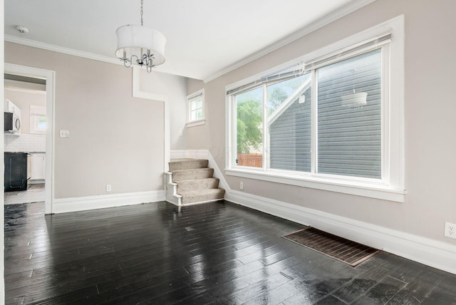 interior space with crown molding, dark hardwood / wood-style floors, and an inviting chandelier