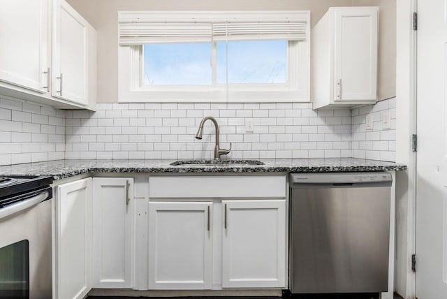 kitchen with decorative backsplash, white cabinets, dark stone counters, and appliances with stainless steel finishes