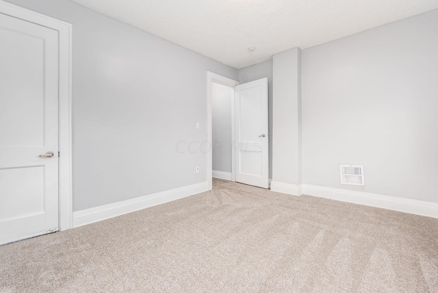 unfurnished room with light colored carpet