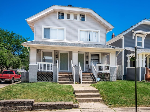 view of front facade featuring covered porch and a front yard