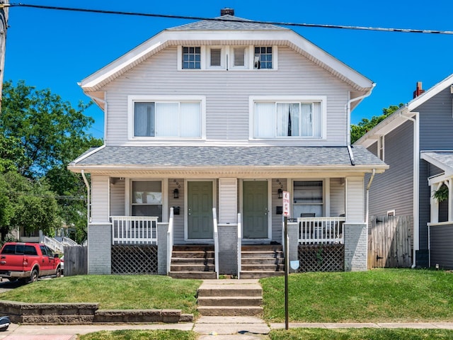 view of front of home featuring covered porch and a front lawn