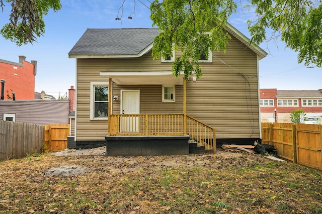 rear view of house featuring central AC unit