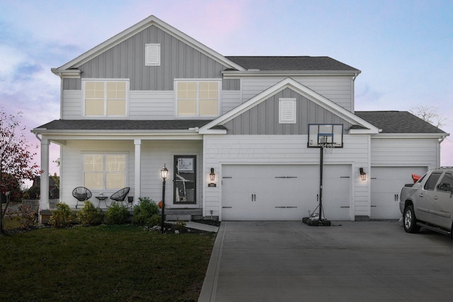 view of front of property featuring a yard and a garage