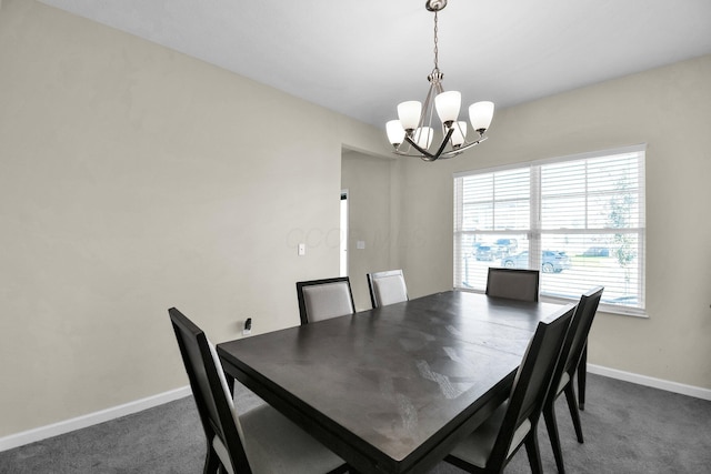 dining area with a notable chandelier and dark carpet