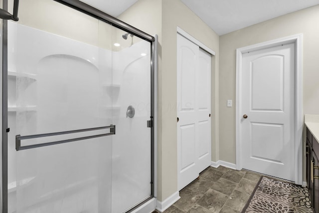 bathroom featuring vanity and a shower with door