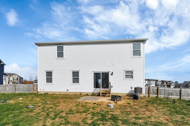 back of property with a yard and cooling unit