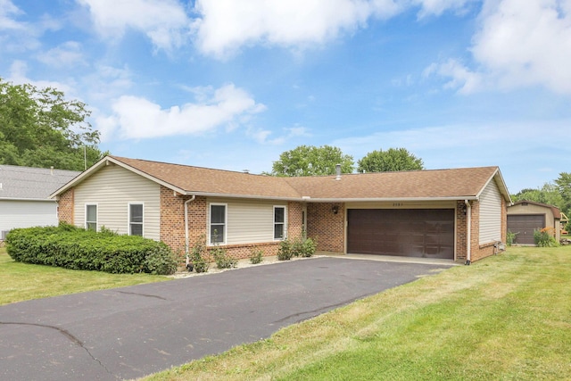 ranch-style house with a garage and a front lawn