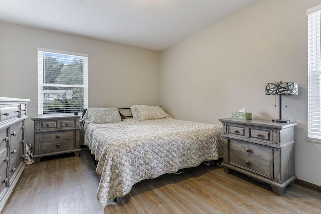 bedroom with dark wood-type flooring