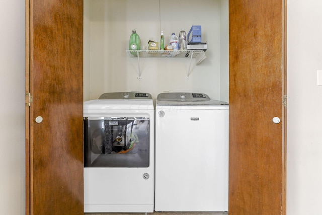 washroom with washing machine and clothes dryer