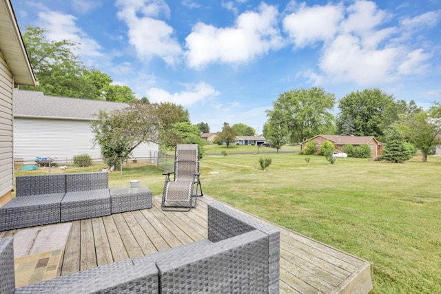 deck featuring outdoor lounge area and a yard