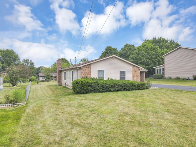 view of side of property with a yard