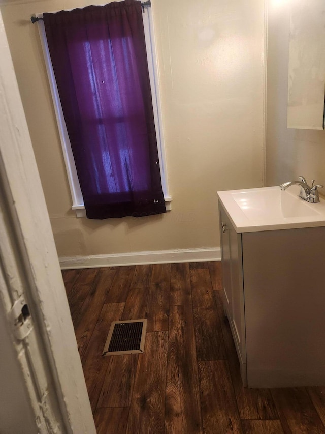 bathroom with hardwood / wood-style flooring and vanity