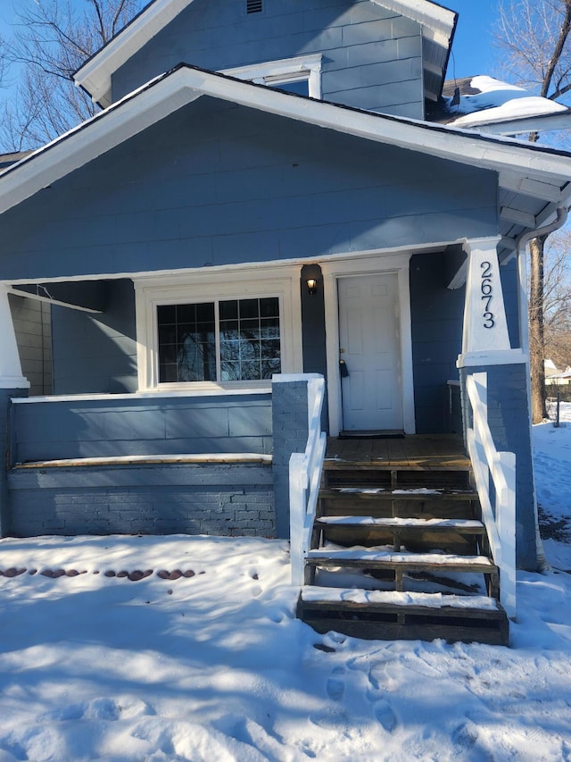 view of snow covered property entrance