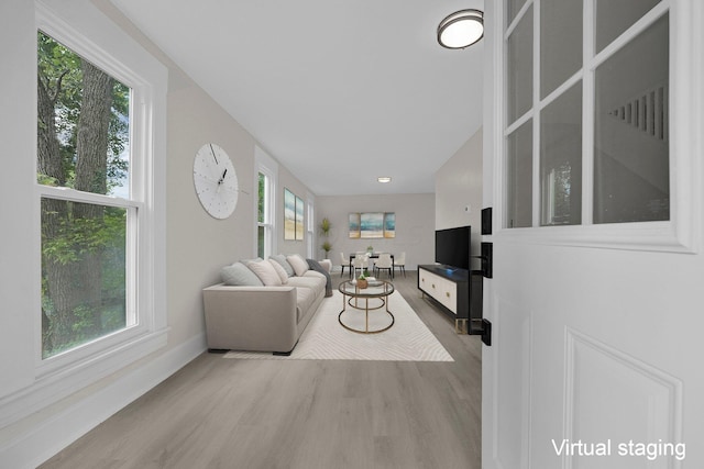 living room featuring light hardwood / wood-style flooring and a wealth of natural light