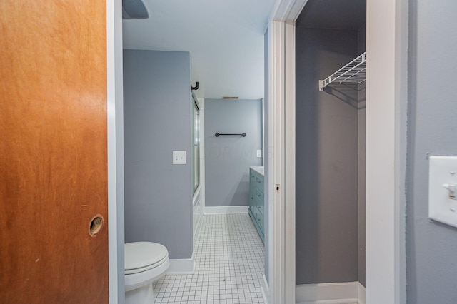 bathroom featuring tile patterned flooring, vanity, and toilet