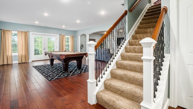 game room with dark hardwood / wood-style floors, pool table, and french doors