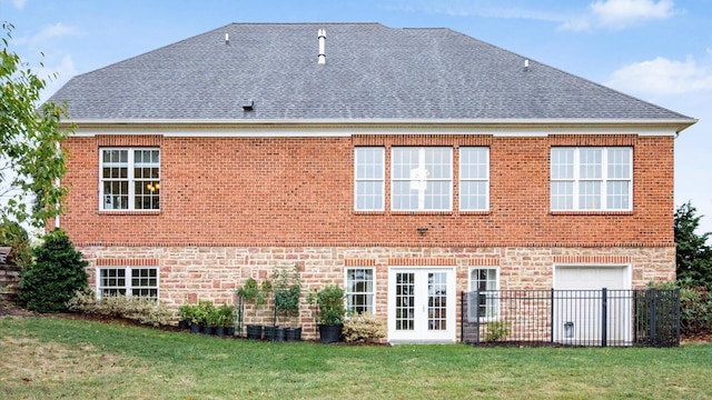 back of house featuring a yard and a garage