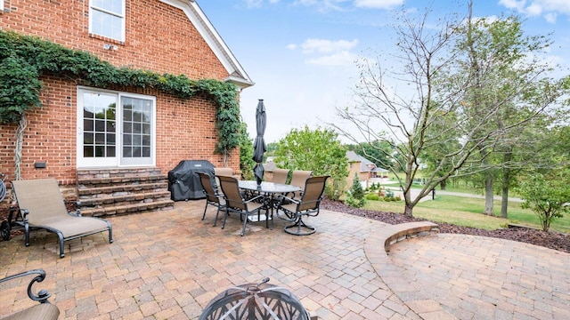 view of patio with a fire pit and a grill