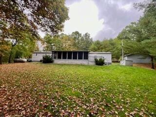 rear view of house featuring a lawn