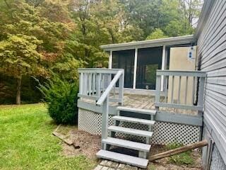 deck featuring a yard and a sunroom