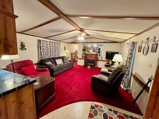 living room with lofted ceiling with beams