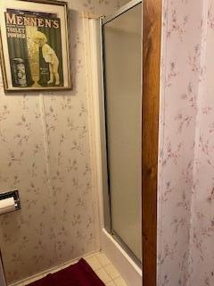 bathroom with tile patterned flooring and walk in shower