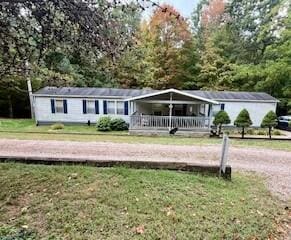 ranch-style house featuring a front lawn and covered porch