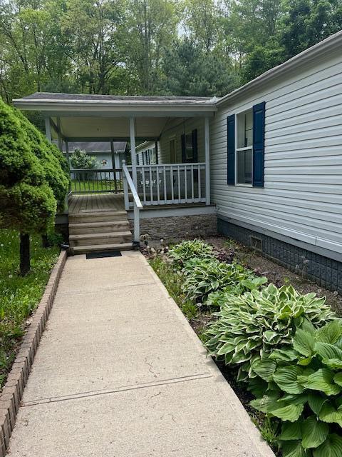 73350 Brooks Martin Rd, Mcarthur, OH 45651 - property entrance featuring a porch, crawl space, and view of wooded area