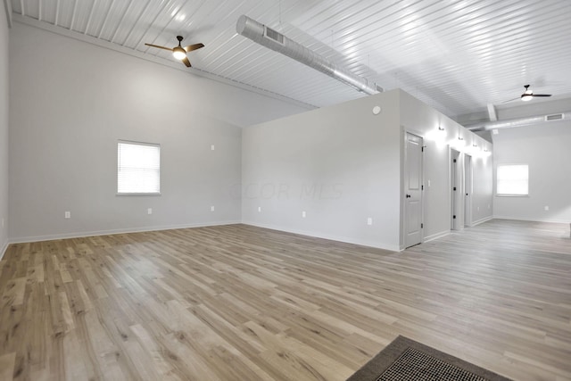 empty room with light hardwood / wood-style floors, ceiling fan, and lofted ceiling