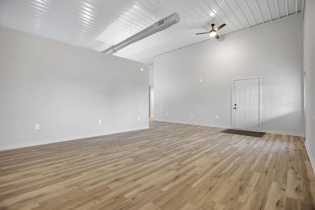 spare room featuring ceiling fan, high vaulted ceiling, and light wood-type flooring