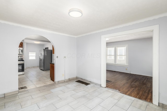 unfurnished room with crown molding