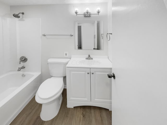 full bathroom with a textured ceiling, vanity, shower / washtub combination, hardwood / wood-style flooring, and toilet