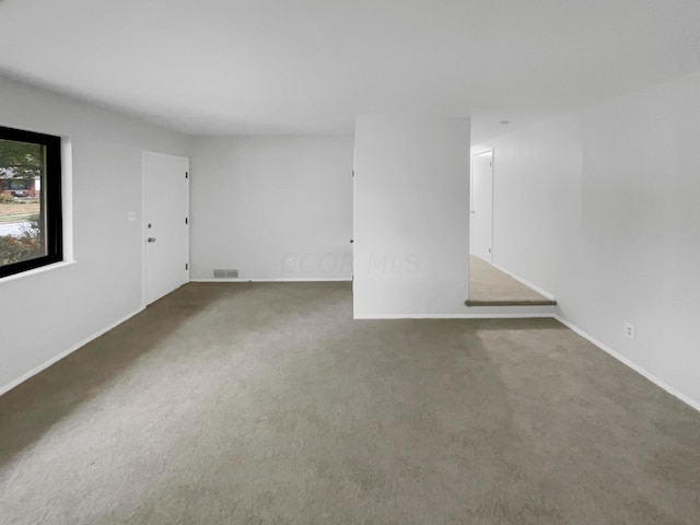 empty room with dark colored carpet