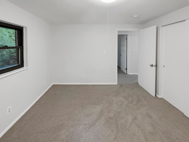 unfurnished room with light carpet