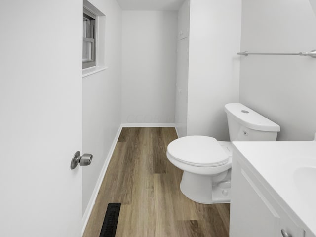 bathroom featuring hardwood / wood-style flooring, vanity, and toilet