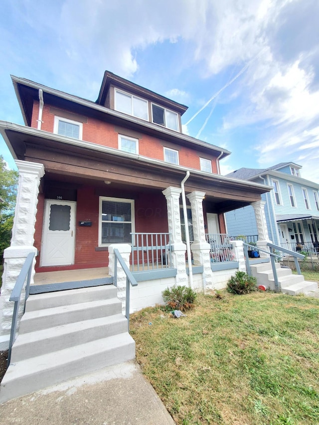 view of front of house with a porch and a front lawn