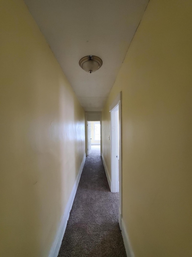 corridor with dark colored carpet